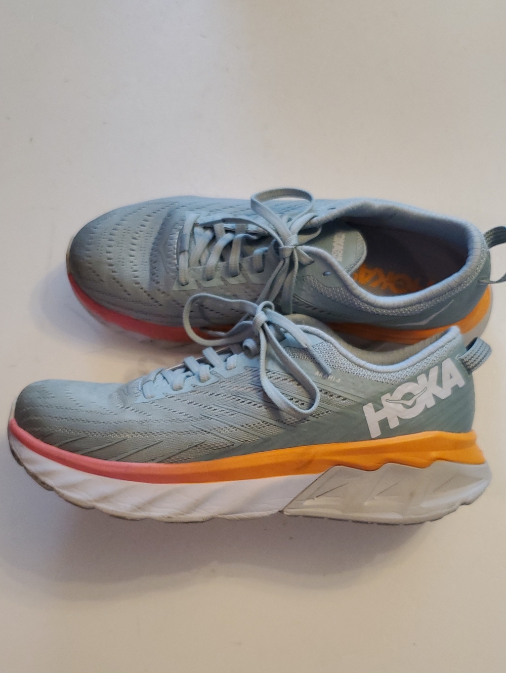 Hoka Light Teal Running Shoes with Orange and Coral Accents